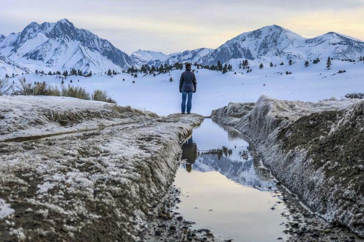 A Person Standing on Snow Covered Ground
